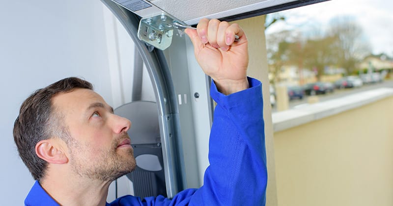 Close up of man installing garage door
